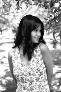 Portrait of woman standing against plants