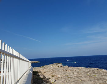 Scenic view of sea against blue sky