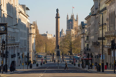 View of city street and buildings against sky