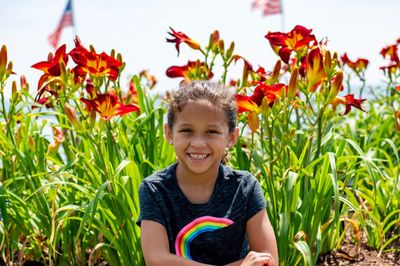 Portrait of smiling girl against flowering plants