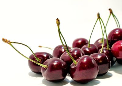 Close-up of cherries against white background