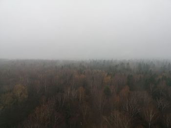 Scenic view of field against sky during foggy weather
