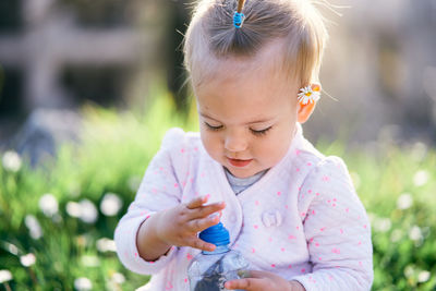 Close-up of cute girl holding plant