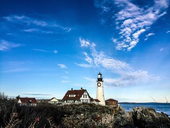 Lighthouse against cloudy sky