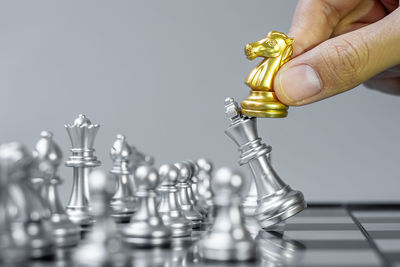 Close-up of hand holding chess pieces