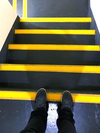 Low section of man standing on staircase