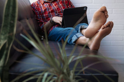 Relaxed man on the sofa using digital tablet