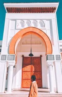 Low angle view of woman standing outside building