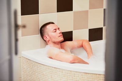 Midsection of man in bathroom