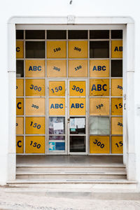 Text on yellow door of building