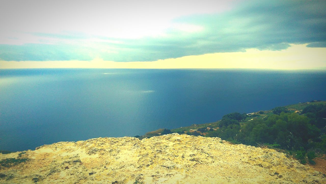 tranquil scene, sea, scenics, tranquility, sky, water, beauty in nature, horizon over water, nature, cloud - sky, idyllic, mountain, cloud, rock - object, blue, non-urban scene, remote, cloudy, coastline, day