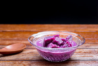 Close-up of pink juice in glass bowl on table