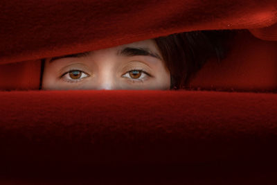 Portrait of a serious young woman with red eyes