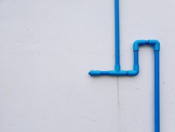 Water supply pipe on white concrete wall