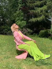 Midsection of woman sitting on field