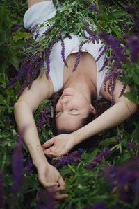 High angle view of woman relaxing on field