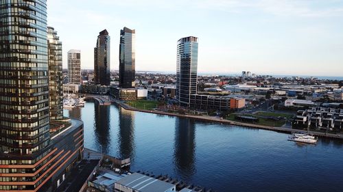 River amidst buildings in city against sky