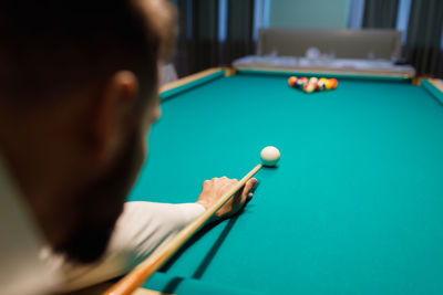 Cropped hand playing pool