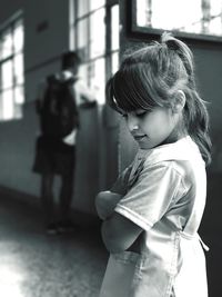 Schoolgirl standing in corridor