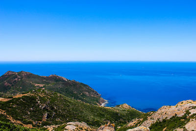 Scenic view of sea against clear blue sky