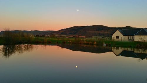 Scenic view of lake at sunset