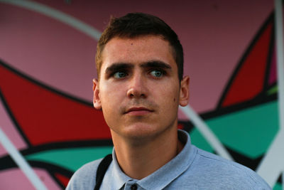 Man face. 20s man standing near shopping mall. summer day. portrait of young man. copy space. 