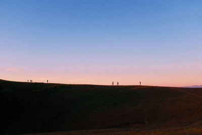Scenic view of silhouette landscape against clear sky during sunset