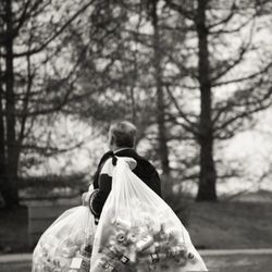 Rear view of couple walking on bare tree
