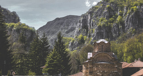 Panoramic view of trees and buildings against sky