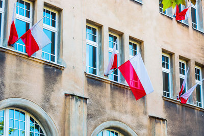 Low angle view of flags hanging on building