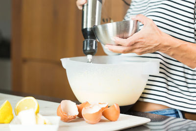 Midsection of person pouring water