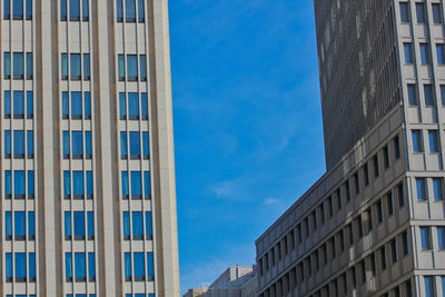 Low angle view of modern building against blue sky