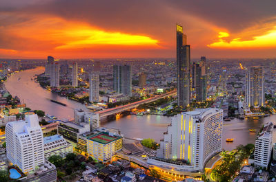 Aerial view of modern buildings against sky during sunset