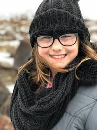 Portrait of a smiling young woman in snow