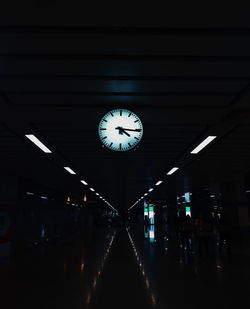 Illuminated railroad station platform at night