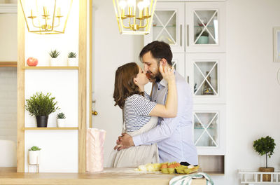 Young couple standing at home