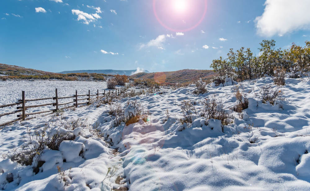 SNOW COVERED LANDSCAPE AGAINST SKY