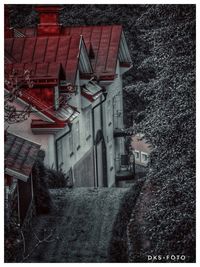 Street amidst houses in town during winter