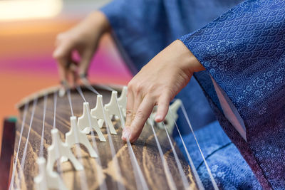 Midsection of person playing musical instrument