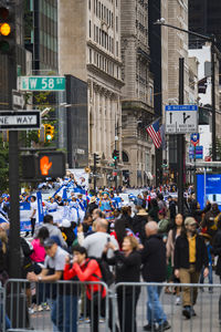 Group of people walking on street in city