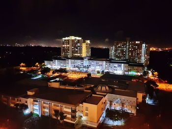 High angle view of illuminated buildings in city at night