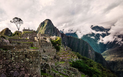 Scenic view of mountains against cloudy sky