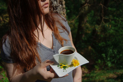 Midsection of woman holding tea