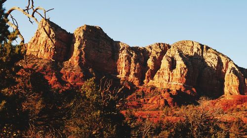 Rock formations on mountain against clear sky