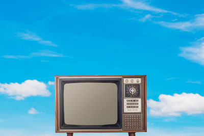 Low angle view of television against sky