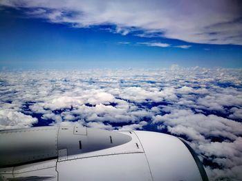 Aerial view of cloudscape over airplane wing