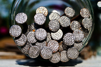 Close-up of screws in jar on table