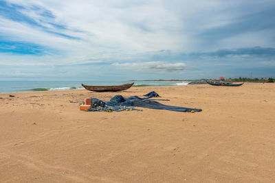 Fishing boat and fishing net on the beach waiting for the next fishing trip in keta ghana