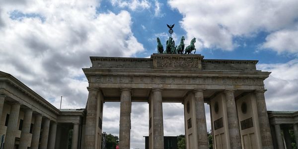 Low angle view of statue against cloudy sky