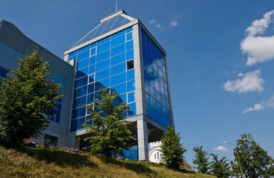 Low angle view of modern building against blue sky